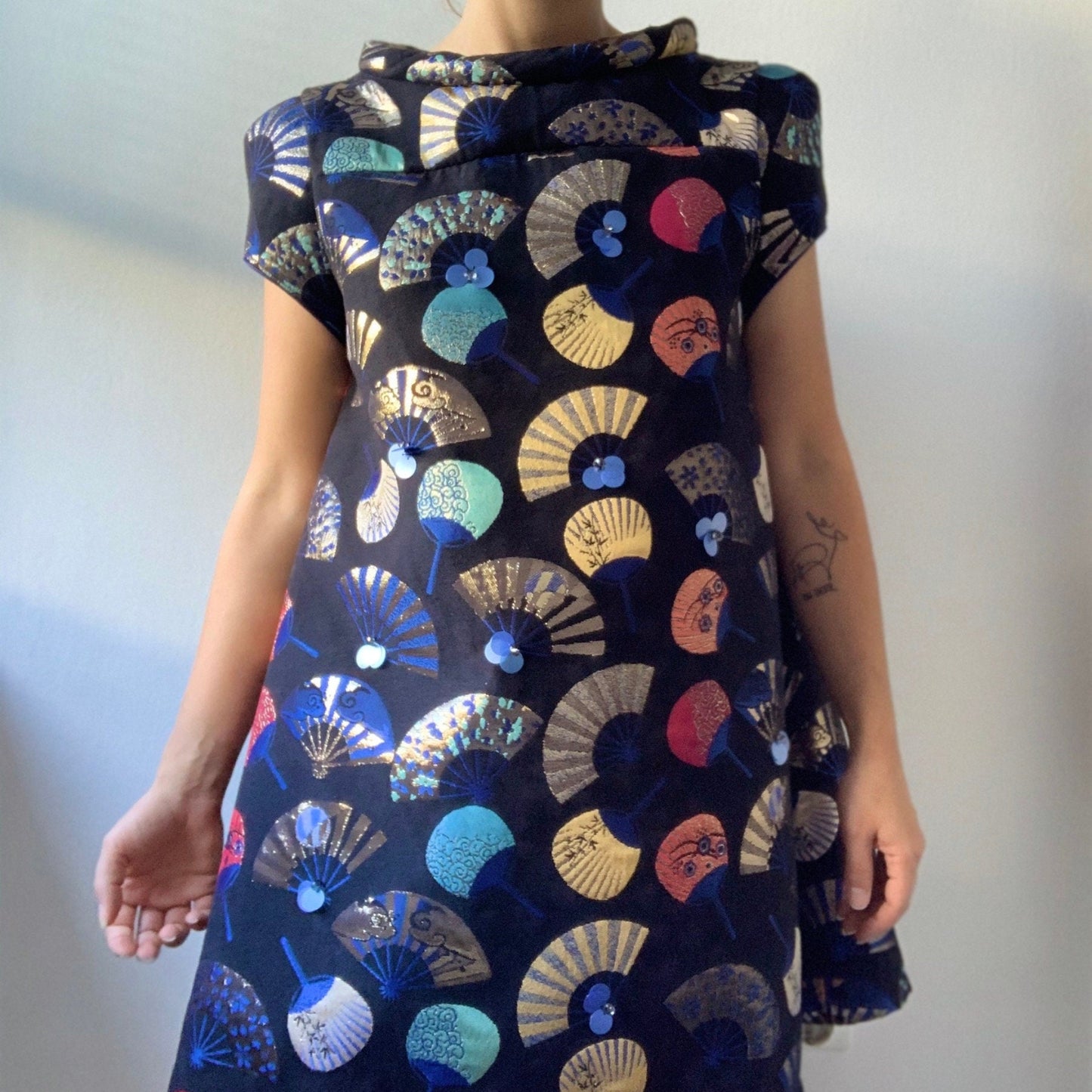 Dress with colorful fan pattern on a plain background