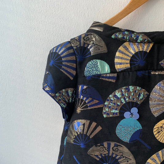 Black dress with colorful fan patterns on a white background