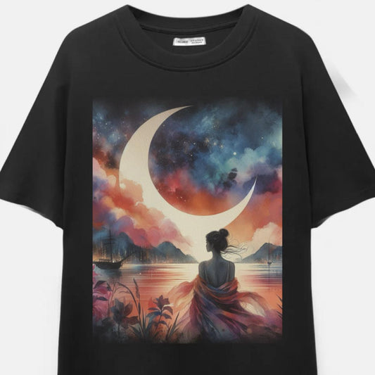Black t-shirt with a colorful graphic of a woman sitting by a lake with a crescent moon and mountains.