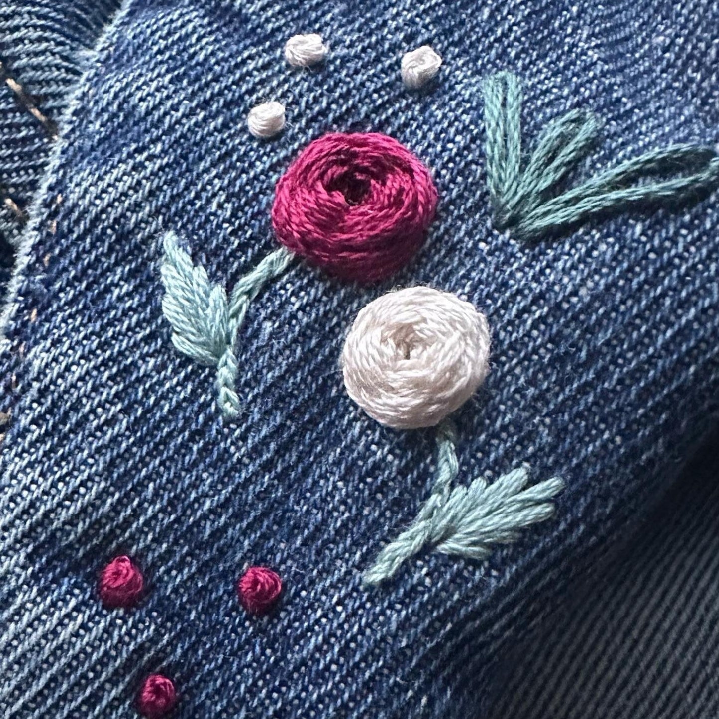 Embroidered flowers on denim fabric