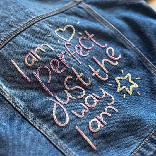 Denim jacket with embroidered text 