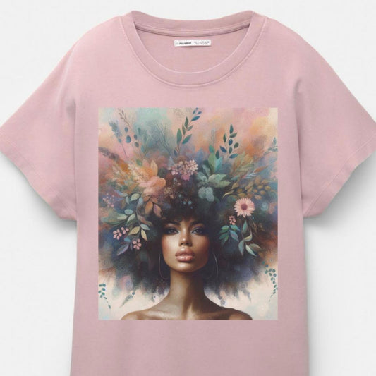 Pink t-shirt with a graphic of a woman with flowers in her hair on a white background