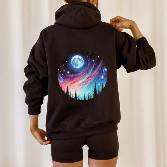 Person wearing a black hoodie with a colorful northern lights design on the back against a plain background