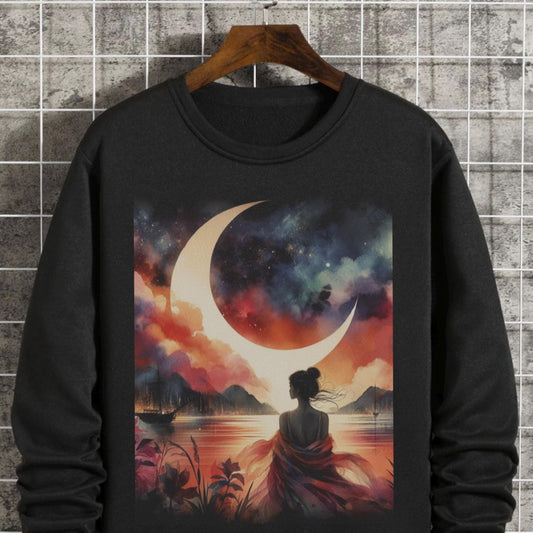 Black sweatshirt with a colorful design of a crescent moon, silhouette, and landscape on a hanger against a tiled wall.