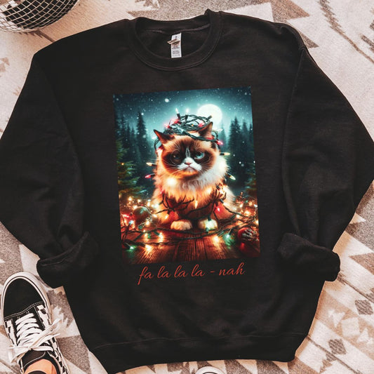 Black sweatshirt with a festive cat design on a patterned floor.